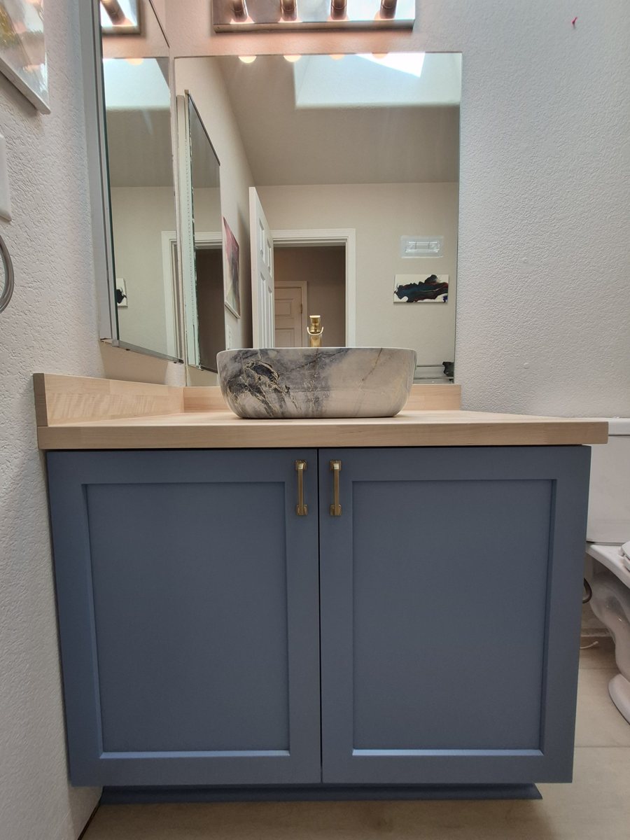 Navy bathroom vanity refinished by Refresh