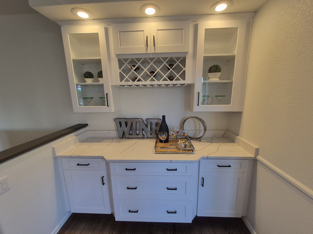 White cabinets and built-in wine nook after refinishing